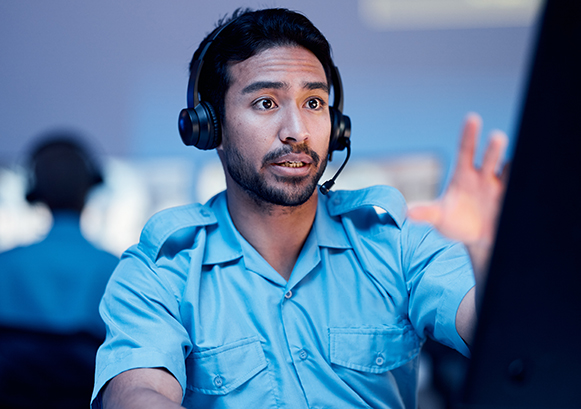 A guy on a phone call in front of his computer