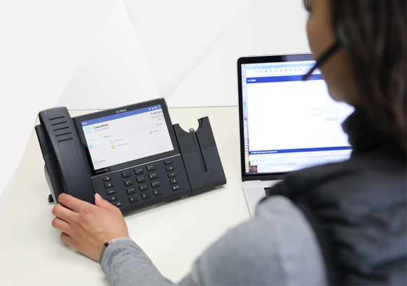 A woman in front of a business phone system