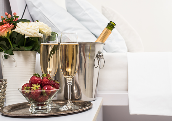 Wine glasses with strawberries and a white wine bottle