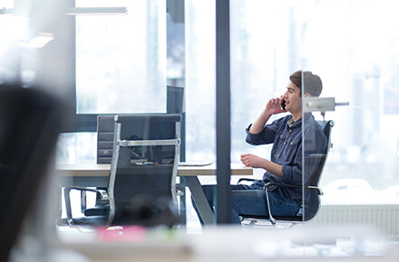A man in a phone call in her desk