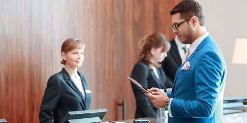 A guy looking at this tablet at a welcome desk