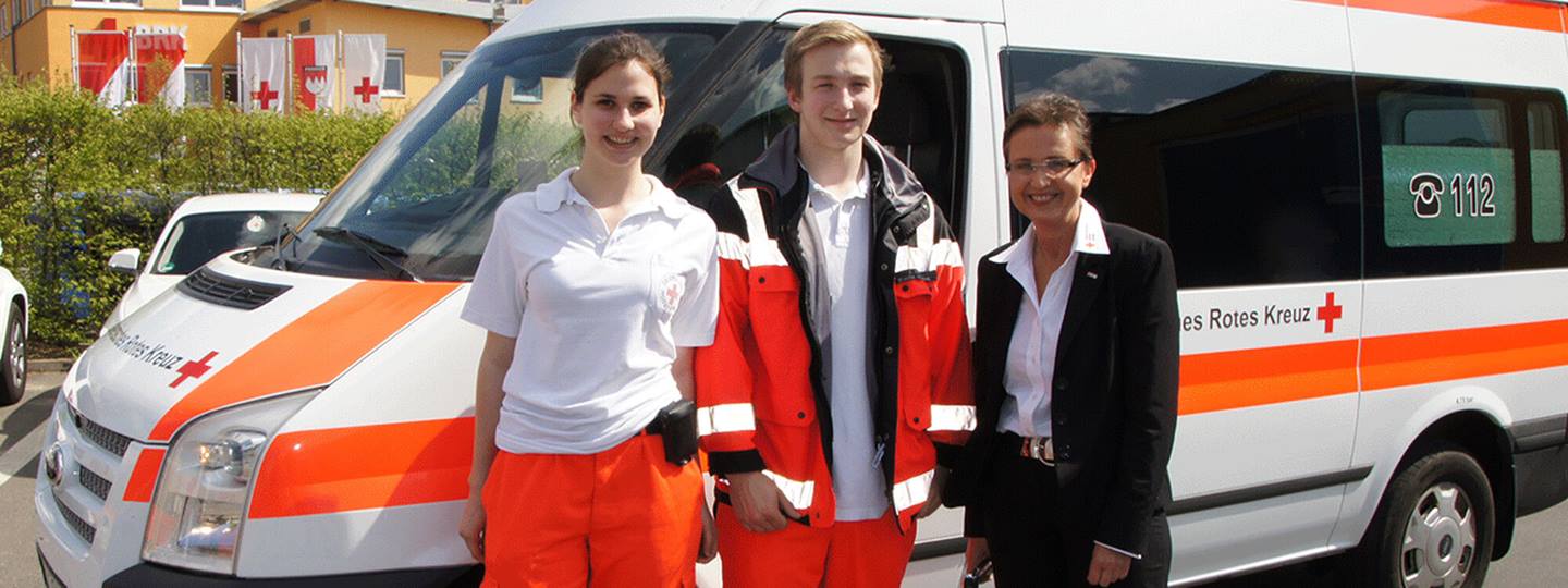 people in front of an ambulance 