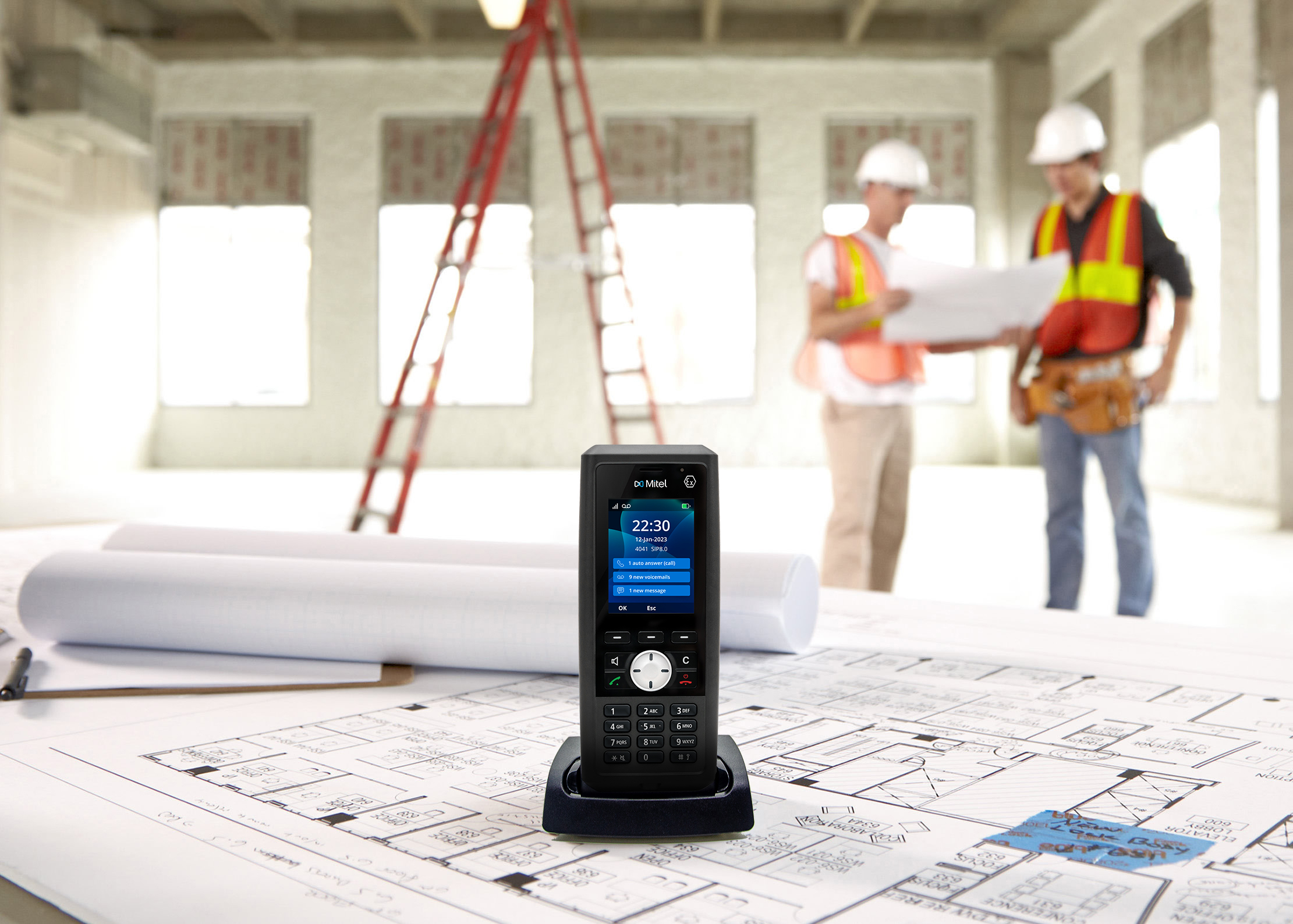Two fields workers and a phone in a front of the image