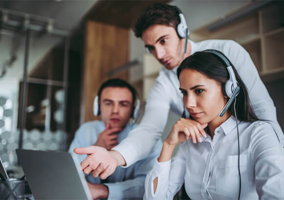 People collaborating in front of a computer