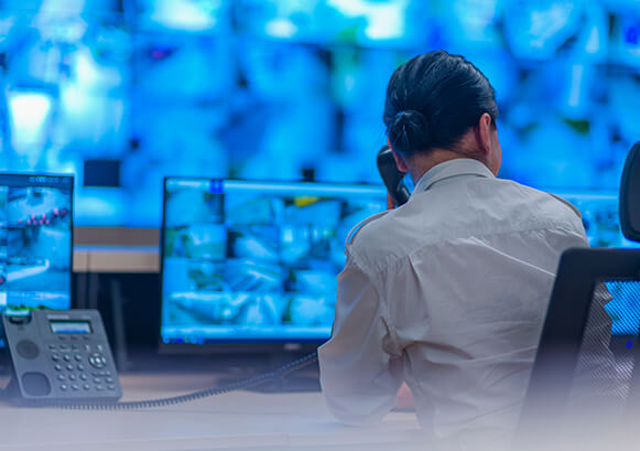 Someone on a phone in a command room