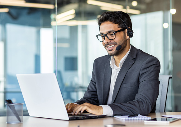 A guy on meeting in front of his laptop