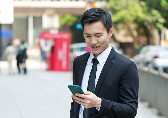 Man looking at his phone outside