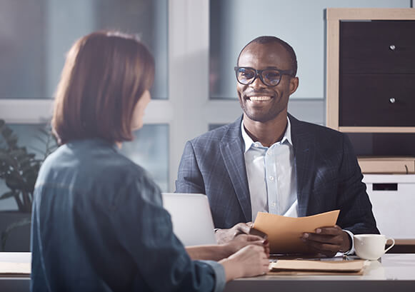 Two people working and talking together