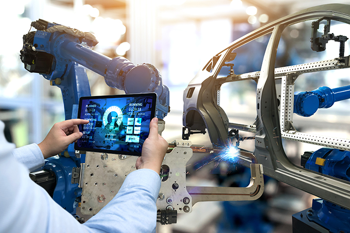Car manufacturing engineer on tablet