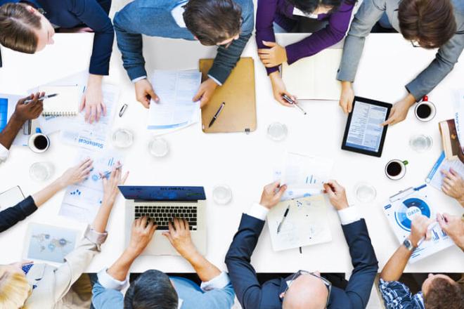People that are collaborating around a table